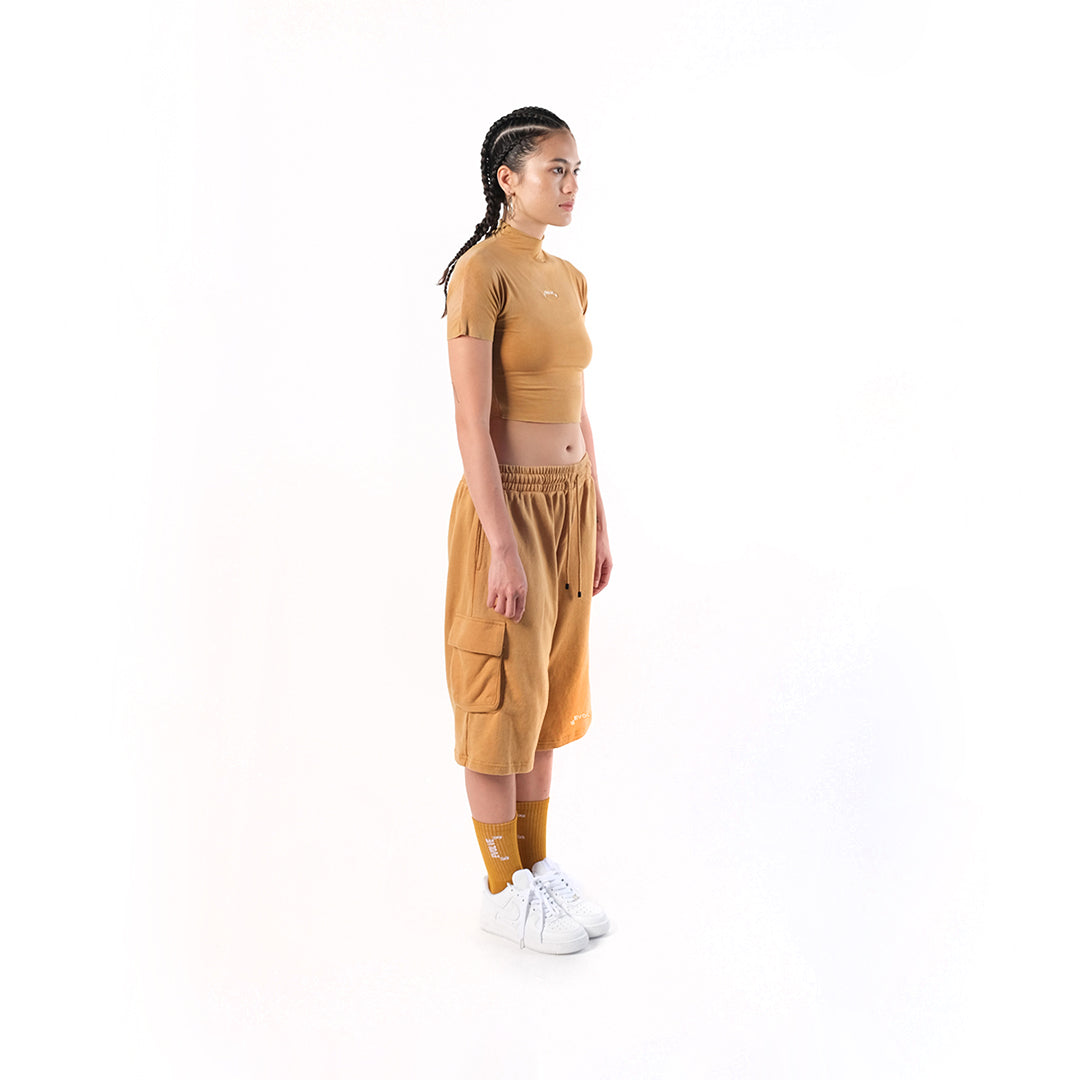 Gym Short Mustard. Cotton Baby Terry. Acid stonewashed. Two side pockets. Two back pockets. Drawstring at elasticized band. Cold machine wash. Unisex