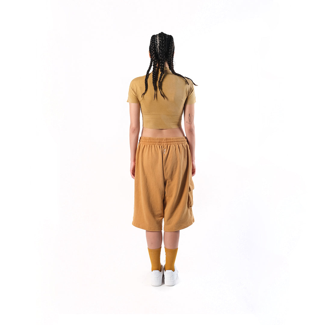 Gym Short Mustard. Cotton Baby Terry. Acid stonewashed. Two side pockets. Two back pockets. Drawstring at elasticized band. Cold machine wash. Unisex