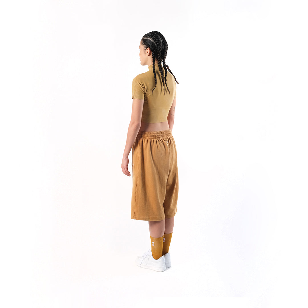 Gym Short Mustard. Cotton Baby Terry. Acid stonewashed. Two side pockets. Two back pockets. Drawstring at elasticized band. Cold machine wash. Unisex