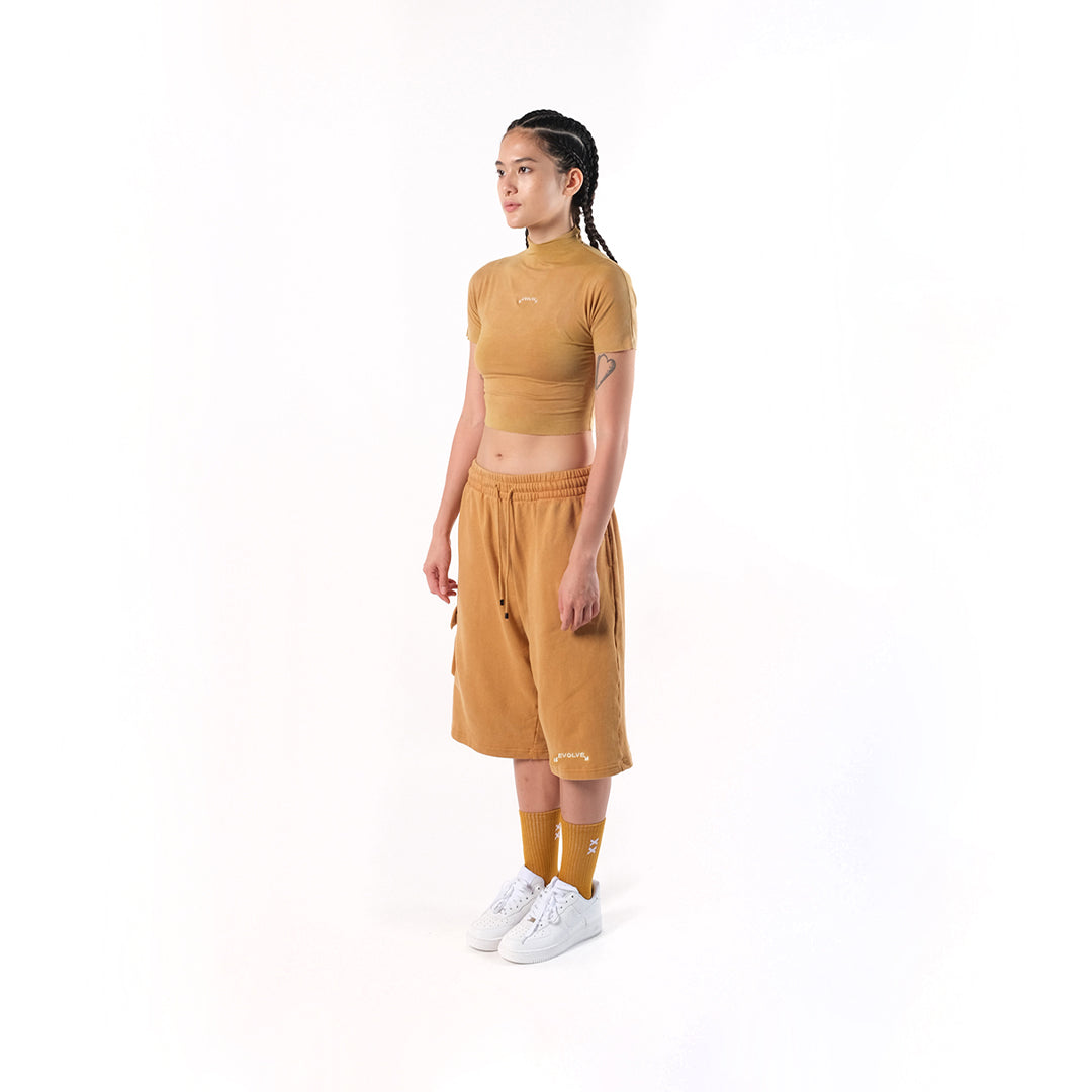 Gym Short Mustard. Cotton Baby Terry. Acid stonewashed. Two side pockets. Two back pockets. Drawstring at elasticized band. Cold machine wash. Unisex